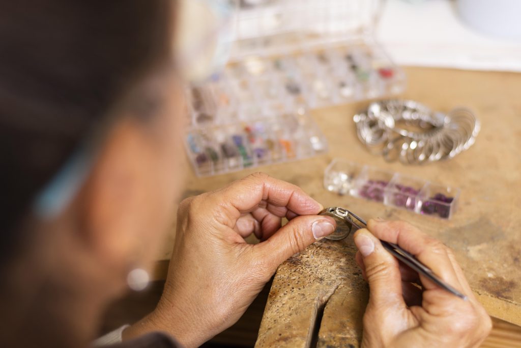 Home 47 jeweler hands putting jewel ring
